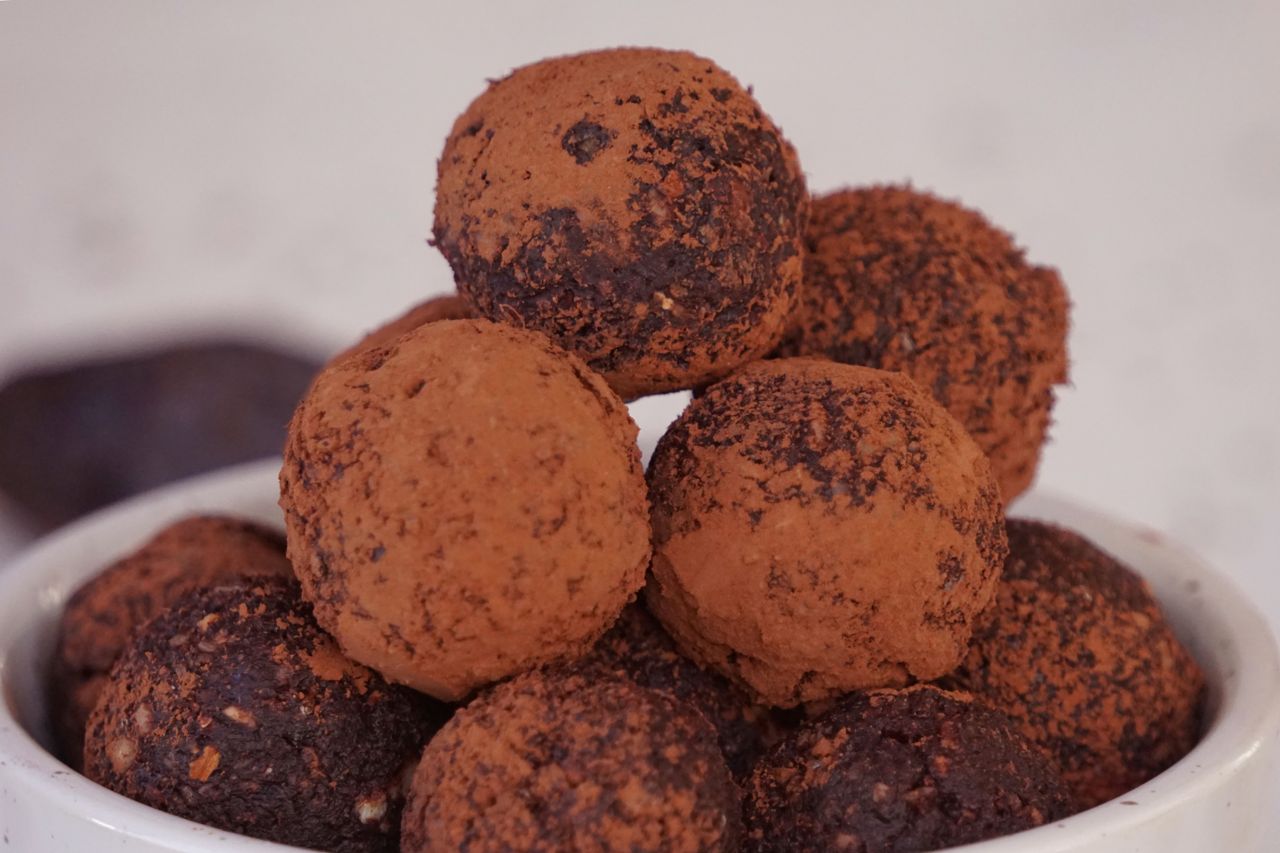 Home Indulgent homemade chocolate truffles coated with cacao for a sweet dessert treat.